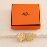 Hermès 2000 Matte Gold Script Logo Clip-On Earrings