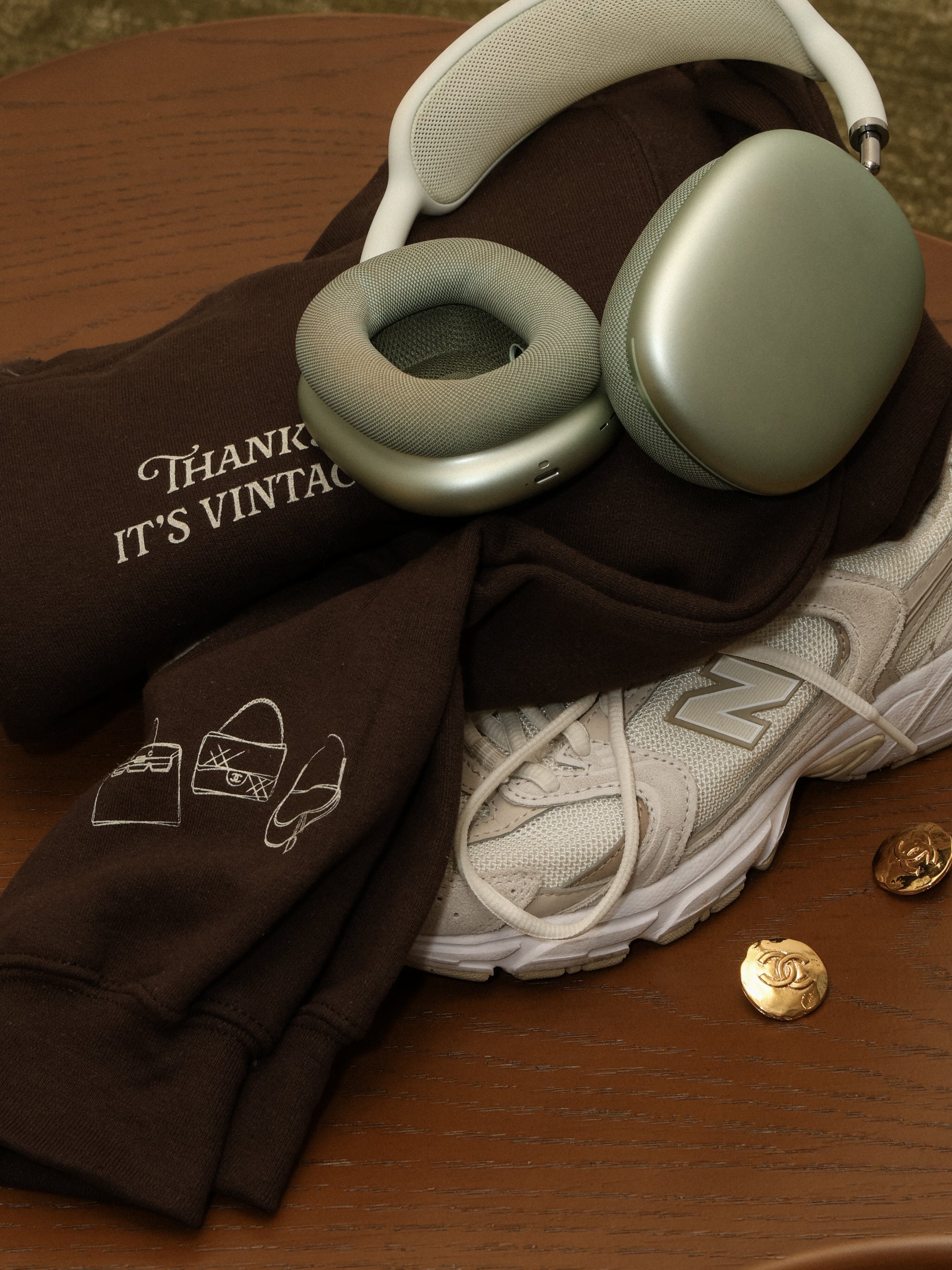 Headphones on a brown surface with a t-shirt and sneakers