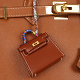 Hermès 2021 Gold Tadelakt Micro Kelly Twilly Bag Charm GHW - FashioNica